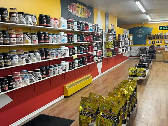 Supplement shelves along the wall at Muscle Depot