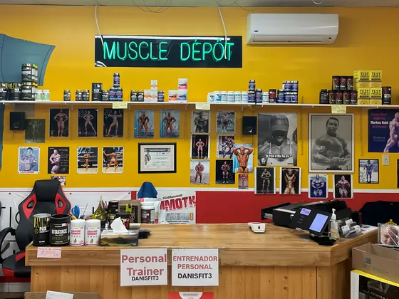 Muscle Depot counter with the neon sign